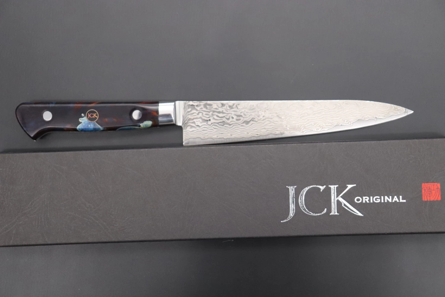 JCK Original Kagayaki NOVEL- Limited Edition Custom R-2 Damascus Series KNLTD-99 Petty 150mm (5.9 Inch, Hammer Forged Blade) 8 JCK Original Kagayaki NOVEL- Limited Edition Custom R-2 Damascus Series KNLTD-99 Petty 150mm (5.9 Inch, Hammer Forged Blade) - Image 8